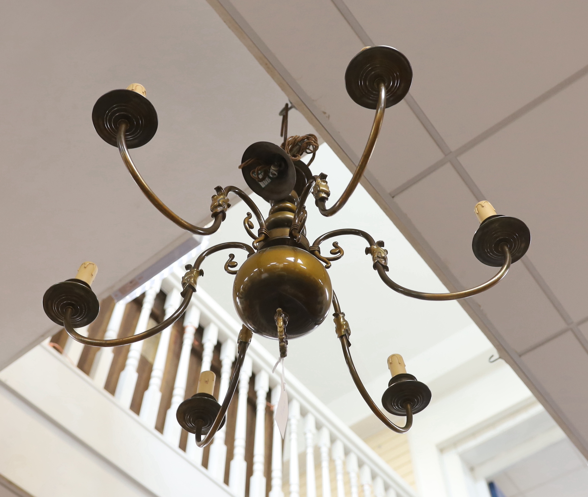 A Dutch style brass chandelier and three brass wall sconces